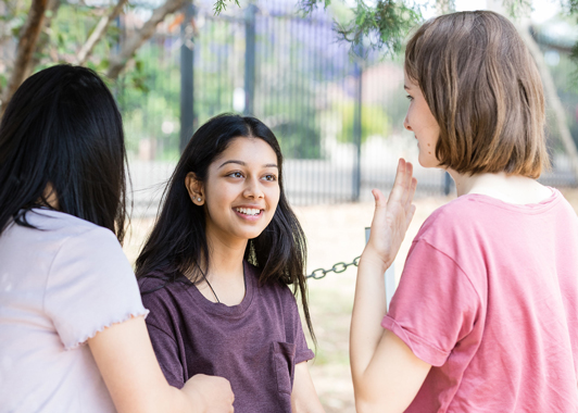 Three students talking outside